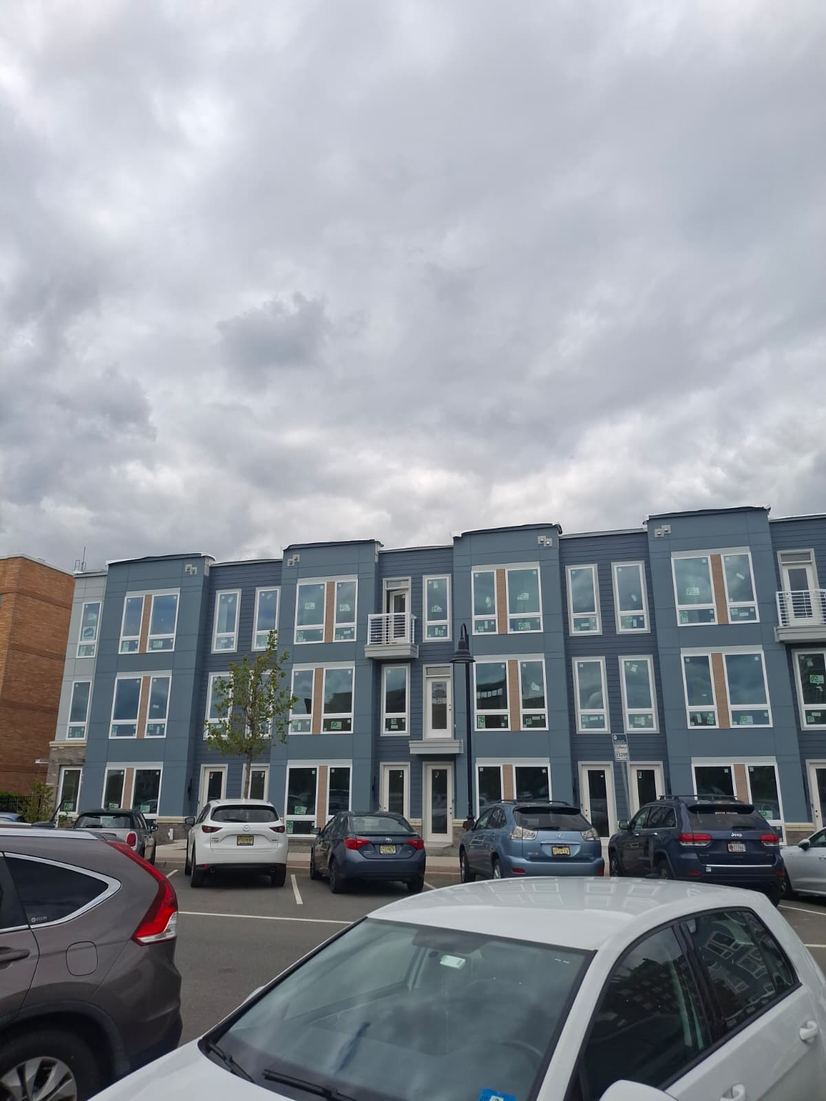 Full elevation of finished beach townhome block with alternating blue panel bays