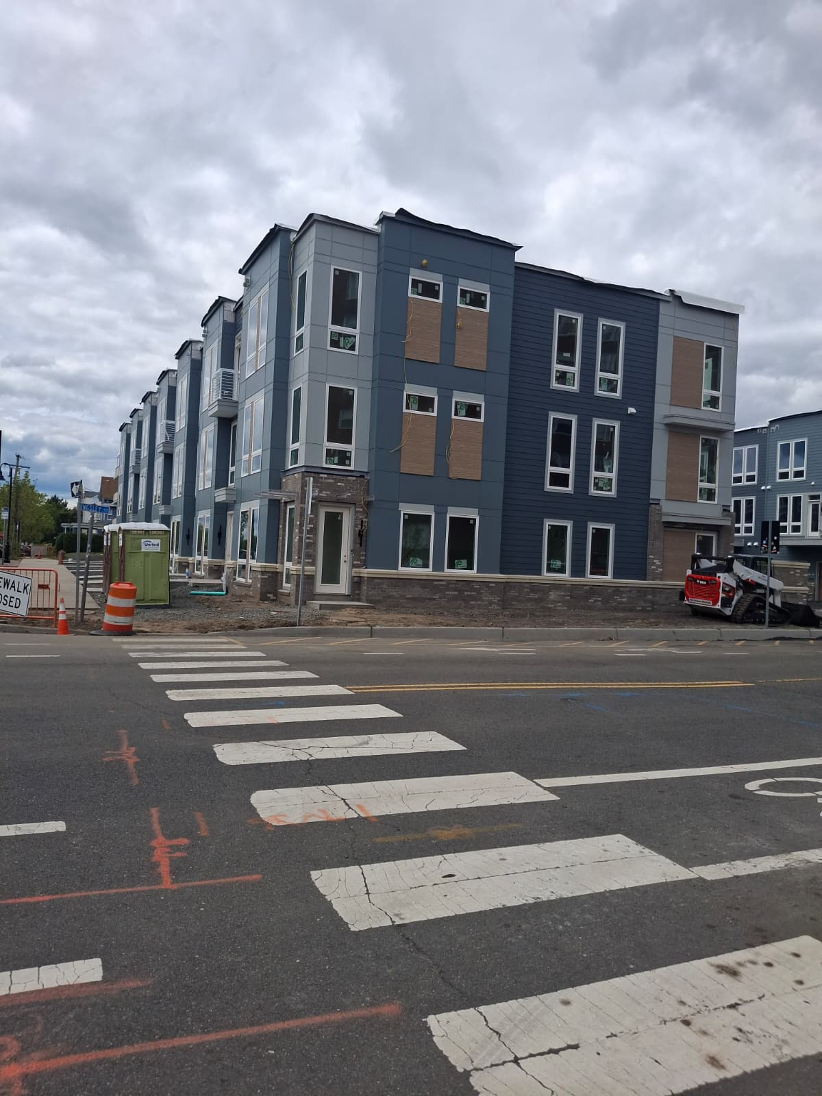 Finished street corner of the beach townhome block with mixed cladding and brick base