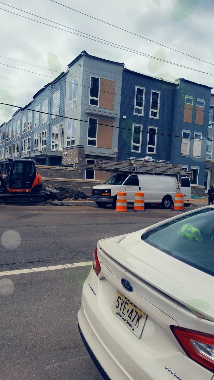 Beach townhome block mid-install with mixed panel and plank cladding going up